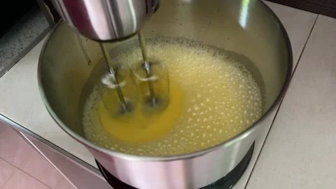 Automatic Mixer Beating Eggs with Person Manually Rotating the Bowl 스톡 동영상 305564406