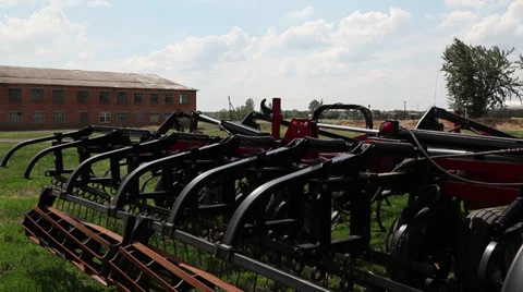 Automatic modern harrow mounted on tractor. Cultivator and farm equipment demons Stock Footage 38287303