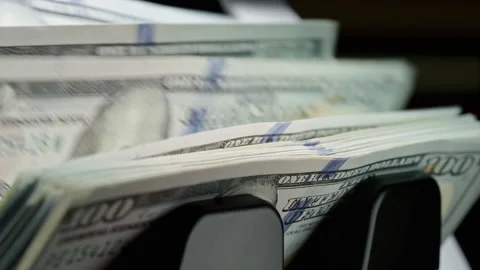 Automatic money counting machine processes stacks of US dollar bills Stock Footage 340026430