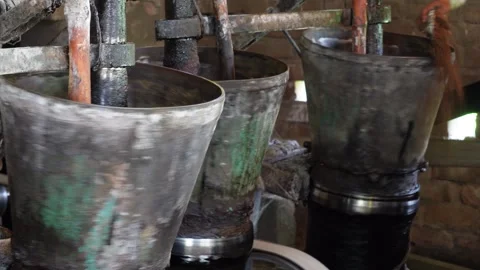 An automatic mortar and pestle system being used for making mustard oil Stock Footage 314513100