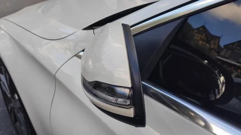 Automatic open wing mirror, inside car view, 4K, soft focus. Stockbeeldmateriaal 253768636