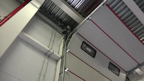 Automatic opening of the sectional garage door with a roller mechanism. Video stock 72073170