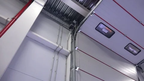 Automatic opening of the sectional garage door with a roller mechanism. Video stock 73714687