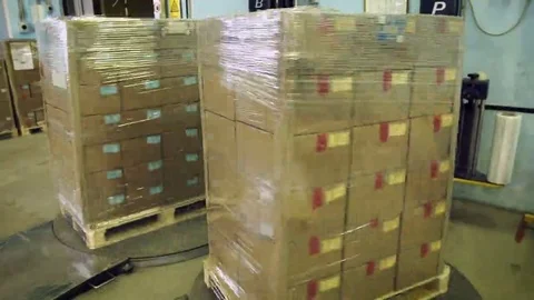 Automatic packing of boxes with plastic wrap Stock Footage 69221361