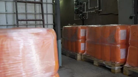 Automatic packing machine wrapping pallet of plastic drums Stock Footage 325766269