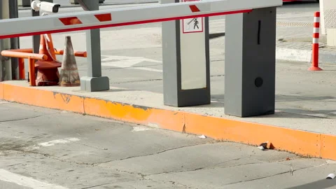 Automatic Parking Barrier Gates Control Vehicle Access Near a Busy City Road Stock Footage 335778067