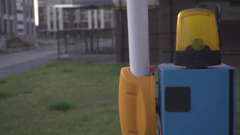 Automatic parking barrier is open to enter a private area,close-up,blinking l Foto stock