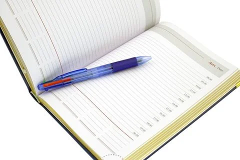 Automatic pen lies on the weekly on a white Stock Photos