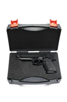 Automatic pistol in a black plastic box Stock Photos