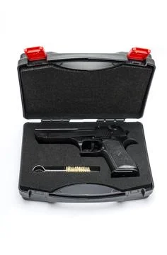 Automatic pistol in a black plastic box Stock Photos