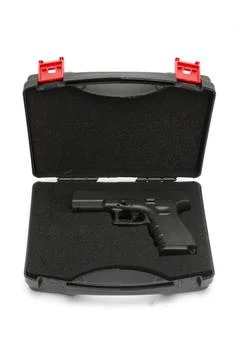 Automatic pistol in a black plastic box Stock Photos