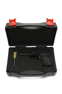 Automatic pistol in a black plastic box Stock Photos