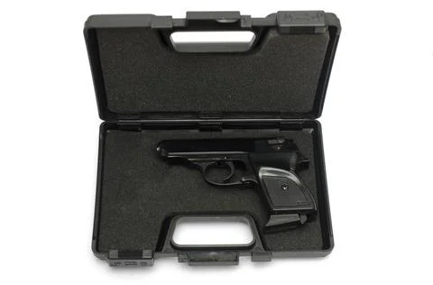 Automatic pistol in a black plastic box Stock Photos