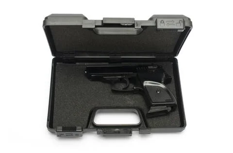 Automatic pistol in a black plastic box Stock Photos