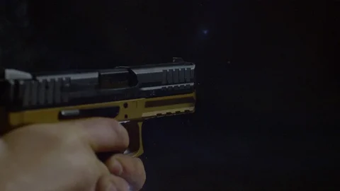 Automatic pistol firing two bullets, Ultra Slow Motion Video stock 86584730