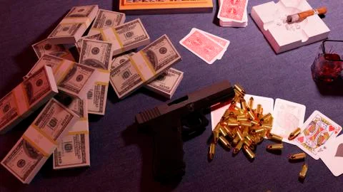 Automatic pistol. The gun is on the table against the background of falling Illustrazione stock
