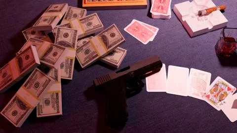 Automatic pistol. The gun is on the table against the background of falling Illustrazione stock