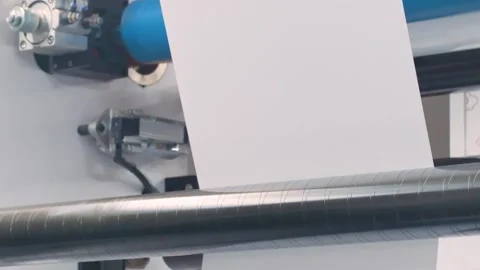 Automatic plastic bag making machine with lighting effect. Close-up of rotati Stock Footage 312117272