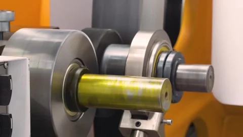 Automatic plastic bag making machine with lighting effect. Close-up of rotati Stock Footage 312118226