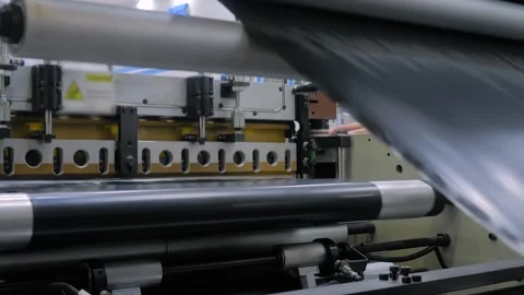Automatic plastic bag making machine: perforating press unit: close up Stock Footage 337061473