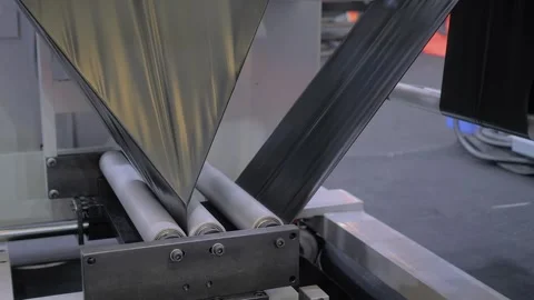 Automatic plastic bag making machine - production of packaging bags: close up Stock Footage 341851414