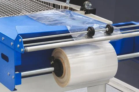 Automatic polyethylene plastic bag production machine with lighting effect. C Stock Photos