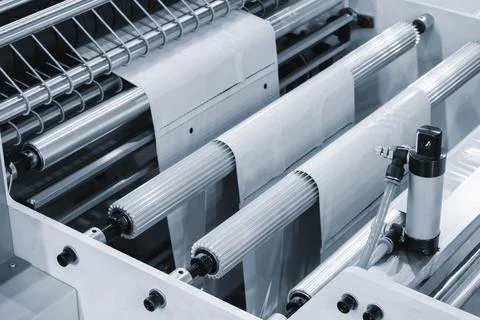 Automatic polyethylene plastic bag production machine with lighting effect. C Stock Photos
