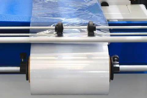 Automatic polyethylene plastic bag production machine with lighting effect. C Stock Photos