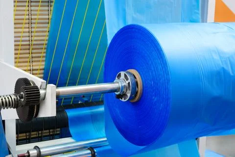 Automatic polyethylene plastic bag production machine. Close-up of roller of  Stock Photos