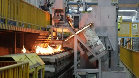 Automatic pouring equipment in a foundry is pouring molten iron into a sand mold Stock-Footage 277430034