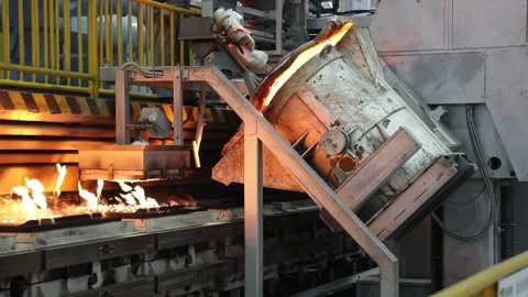 Automatic pouring equipment in a foundry is pouring molten iron into a sand mold Stock-Footage 277430085