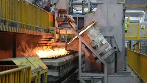Automatic pouring equipment in a foundry is pouring molten iron into a sand mold Stock-Footage 277430141