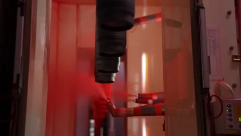 Automatic powder coating guns spray red paint inside booth during fire Stock Footage 347719712