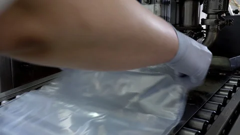 The automatic process of filling and bottling drinking yogurt and cream in the Stock Footage 129961433