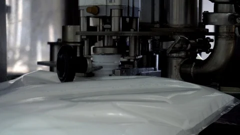 The automatic process of filling and bottling drinking yogurt and cream in the Stock-Footage 129961669