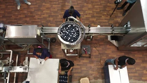 Automatic production line when employee arranging final products into box. Stock Footage 300436791