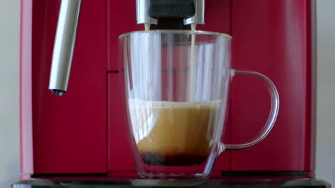 Automatic red coffee machine pins black strong coffee in transparent cup Stock Footage 198587105