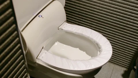 Automatic replacement disposable toilet seat covers. Video has sound. Stock Footage 81695430