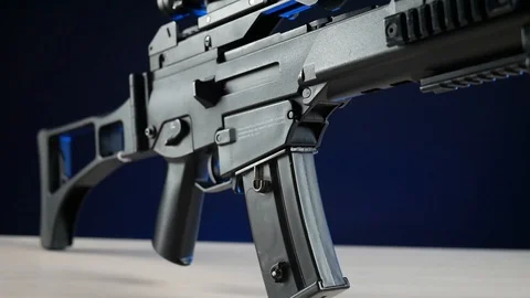 Automatic rifle on a dark background with a telescopic sight Stock Footage 117970037