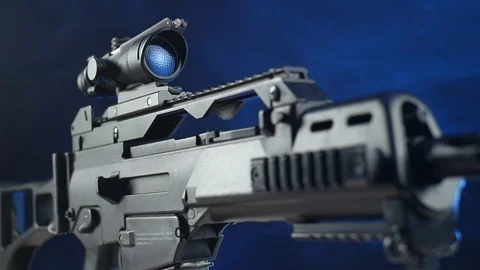 Automatic rifle on a dark background with a telescopic sight Stock Footage 117970074