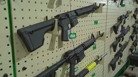 Automatic Rifles at Arms Exhibition. Automatic Weapons Hanging on the White Stock Footage 68605512