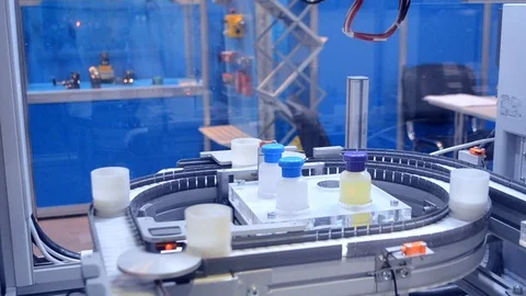 Automatic robot arm hand for conveyor puts objects Stock-Footage 99511216