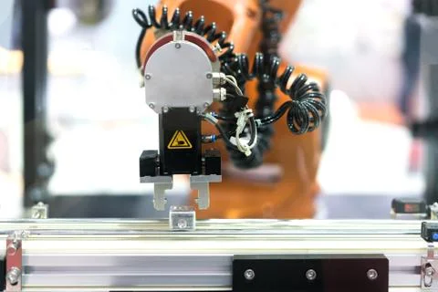 Automatic robot arm with imaging sensor in assembly line working in factory.  Stock Photos