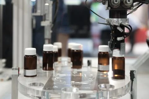 Automatic robot arm with imaging sensor in assembly line working in factory.  Stock Photos