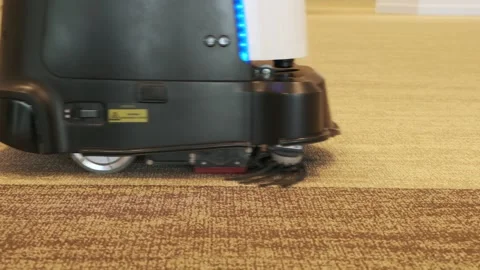 Automatic robot cleaner is vacuuming the carpet of the room. Stock Footage 232233500