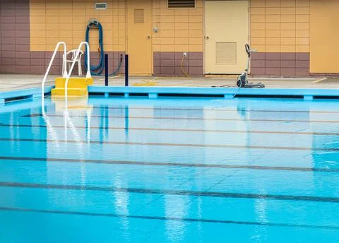 Automatic robot cleans the swimming pool in the public city park Stock Photos