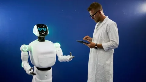 Automatic robot is moving and smiling to developer Stock Footage 123558562