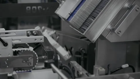 Automatic robot packer feeds cardboard boxes for medicine packaging. Stock Footage 306581283