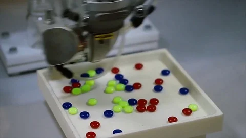Automatic robot pharmaceutical industry. Robot automatically sorting balls Stock Footage 81083576