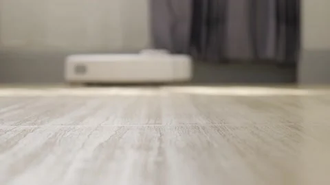 Automatic robot vacuum cleaner cleans the tile floor. Video stock 155219909